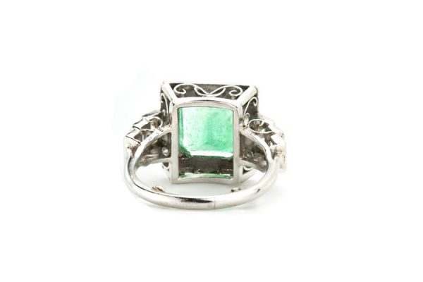4.20ct Natural Colombian Emerald and Baguette Diamond Ring; natural 4.20 carat octagonal-cut Colombian emerald flanked by 0.70cts baguette cut diamond set shoulders, with GCS Certificate