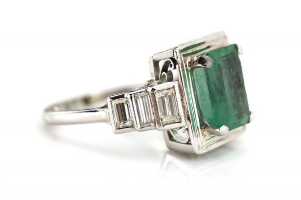 4.20ct Natural Colombian Emerald and Baguette Diamond Ring; natural 4.20 carat octagonal-cut Colombian emerald flanked by 0.70cts baguette cut diamond set shoulders, with GCS Certificate
