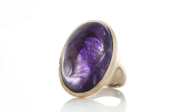 Ancient Carved Amethyst Ring of Berenice, 20.00 carats, produced 300BC-200BC, mounted in a later 18ct gold circa 1980's.
