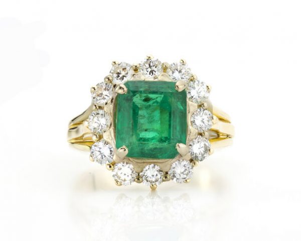 Vintage 3.80ct Natural Colombian Emerald and Diamond Cluster Ring; central 3.80 carat octagonal-cut emerald surrounded by 1.20cts diamonds, 18ct yellow gold, with GCS certificate. Circa 1970's