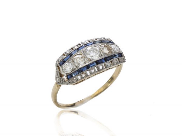 Art Deco Old Cut Diamond and Sapphire Dress Ring; central band of graduating old-cut diamonds flanked by baguette cut sapphires and an outer border of old cut diamonds. Mounted in platinum on an 18ct yellow gold shank. Circa 1920s