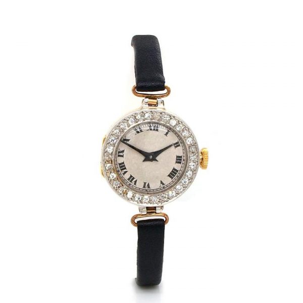 Art Deco Ladies Circular Cocktail Watch with Diamond Bezel, cream face, Roman Numerals, on a black leather strap. Dated London 1925.