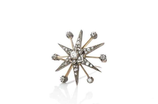 Antique Victorian Old Cut Diamond Star Brooch; set with rose cut and old European cut diamonds, 0.88 carat total, set in silver and 15ct gold