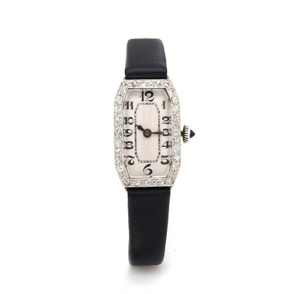 Ladies Art Deco Diamond and Platinum Cocktail Watch; tonneau shaped platinum case, diamond-set bezel, Arabic numerals, black leather strap