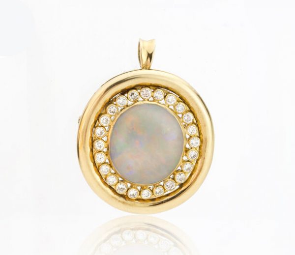 Vintage Opal and Diamond Oval Cluster Pendant Brooch; 10ct oval cabochon natural opal surrounded by 1.20cts brilliant diamonds, 18ct yellow gold, Circa 1970s