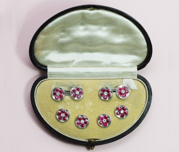 Art Deco Ruby, Diamond and Platinum Cufflink Dress Set; decorated with rubies around central diamond creating a stylish floral design, in original box