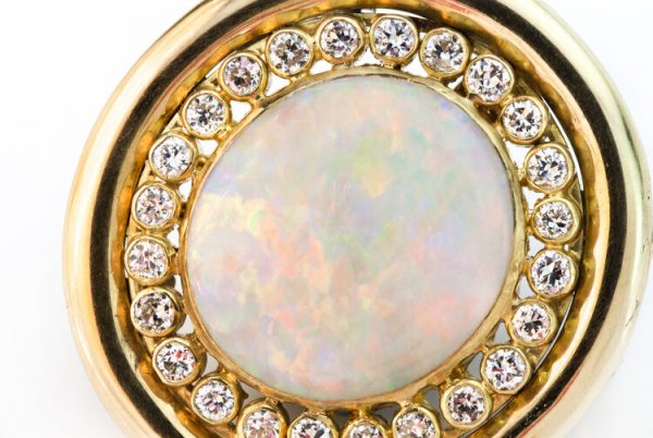Vintage Opal and Diamond Oval Cluster Pendant Brooch; 10ct oval cabochon natural opal surrounded by 1.20cts brilliant diamonds, 18ct yellow gold, Circa 1970s