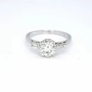 Diamond Solitaire Engagement Ring; round brilliant-cut diamond flanked by baguette diamond set shoulders, 1.04 carat total, in platinum