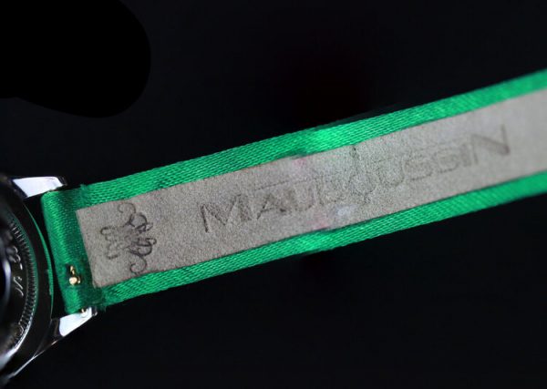 Mauboussin Ladies 18ct Gold and Diamond 26mm Quartz Watch, 18ct gold case, 1.00ct diamond bezel, on a green Mauboussin fabric strap.