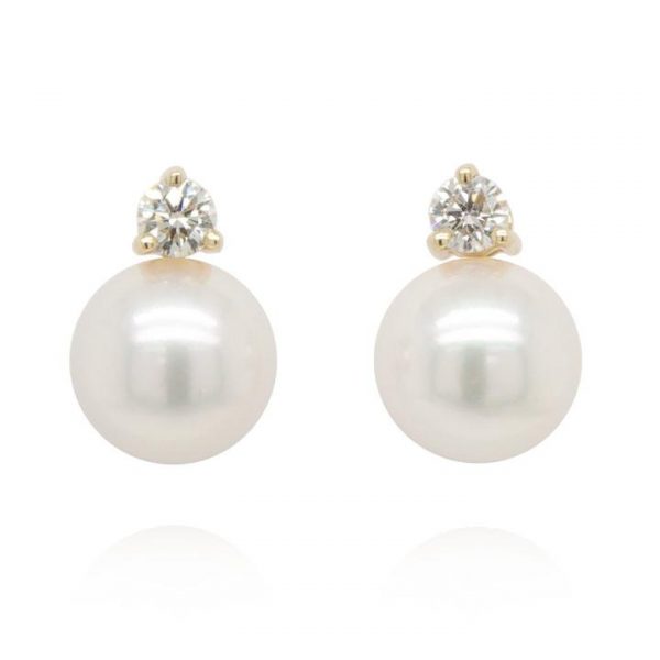 Pair of Pearl and 0.20ct Diamond Earrings; featuring cultured pearl with a brilliant cut diamond claw-set above. Post and butterfly fittings