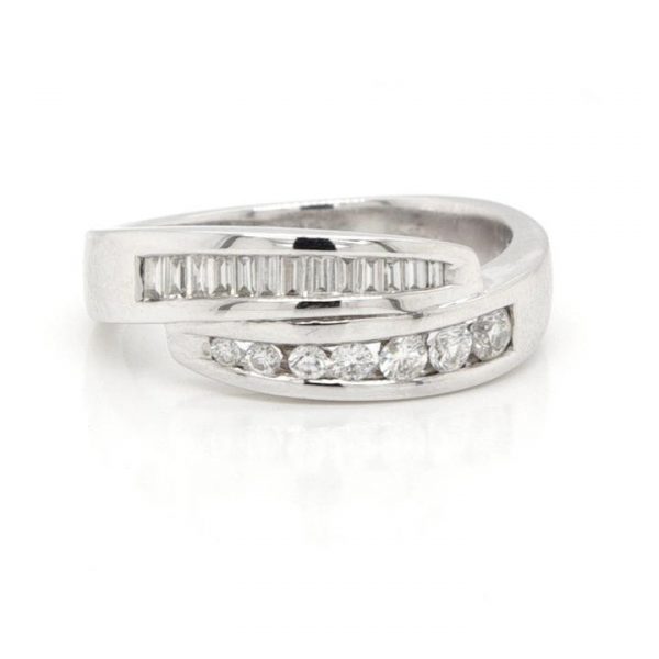 Baguette and Brilliant Cut Diamond Crossover Half Eternity Ring; channel set with baguette and round brilliant-cut diamonds, 0.45 carat total, in 18ct white gold