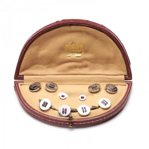 Cartier Vintage Ruby and Platinum Dress Set; comprising a pair of cufflinks, four buttons and two studs set with calibre-cut rubies, in original fitted case, Signed and numbered, Circa 1950