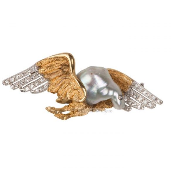 Vintage Diamond Set Winged Bird Brooch; A striking brooch in the form of bird in flight, diamond set eye and feathers, textured wing detail