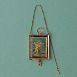 Early 19th Century 18ct Gold Angel Locket; black and gold ‘verre eglomisé’ angel picking roses, miniature key and lock, French gold mark for 1809-1819