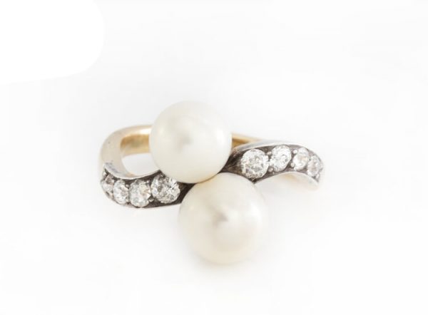 Art Deco Natural Pearl and Old Cut Diamond Ring; set with two natural freshwater pearls, accented with old-cut diamond set shoulders, in 18ct yellow gold. Circa 1920