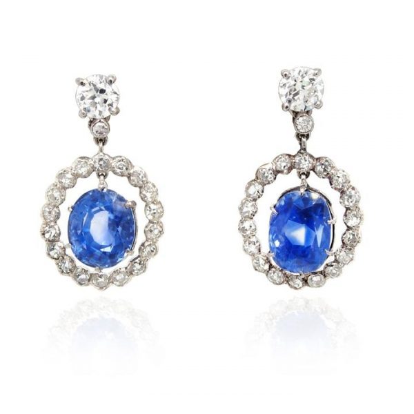 Ceylon Sapphire and Diamond Cluster Drop Earrings; featuring 10.13cts oval faceted Ceylon sapphires within an open surround of old cut diamonds, suspended from 1.20cts diamond studs. Set in silver and gold