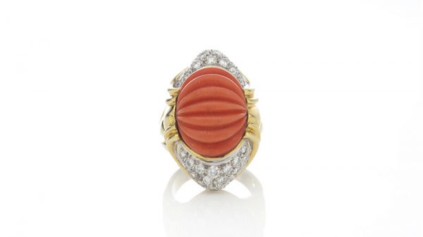 Vintage Carved Coral, Diamond and 18ct Gold Domed Cocktail Ring; set with a natural coral carved with fluid ridges and 1.30cts diamonds. Circa 1950s-1960s