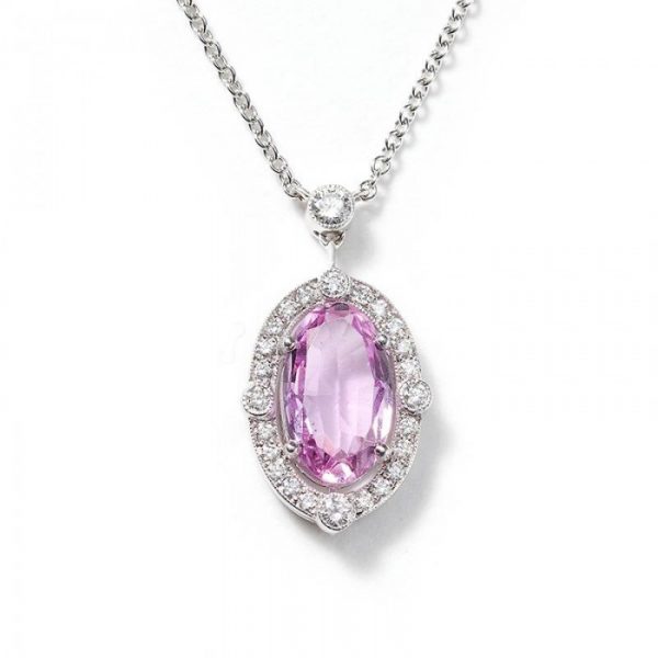 Pink Topaz and Diamond Oval Cluster Pendant, 2.23 carat oval faceted pink topaz surrounded by diamonds. Mounted in platinum