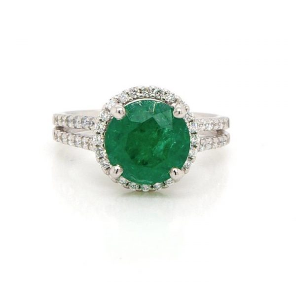 Emerald and Diamond Cluster Cocktail Ring; 2.18ct round faceted emerald within a surround of brilliant cut diamonds and diamond-set shoulders