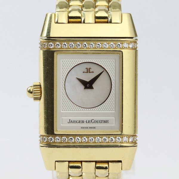 Jaeger LeCoultre Reverso Duetto 18ct Yellow Gold Watch; Ref. 266.1.44, with a 21mm 18ct yellow gold case with reversible dial, switching from silver colour with Arabic numerals to mother of pearl with diamonds running above and below the dial, on an 18ct yellow gold bracelet with hidden double-fold clasp, with Jaeger-LeCoultre box