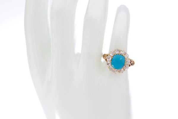 Antique Victorian Turquoise and Old Cut Diamond Cluster Ring; central 2.50ct round cabochon cut turquoise surrounded by 1.65cts old cut diamonds, in 15ct yellow gold, Circa 1870s
