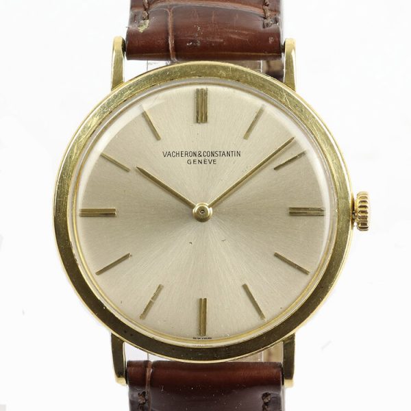 Vacheron Constantin Vintage Gents Thin 18ct Yellow Gold Manual 1960s Watch; the 33mm 18ct yellow gold case has a thickness of 5mm (including the acrylic crystal), silver baton dial, on a brown leather strap