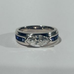 Vintage Marquise Diamond and Sapphire Band Ring; set with a 1.25ct marquise cut diamond with square cut sapphire shoulders, in platinum, Circa 1980s