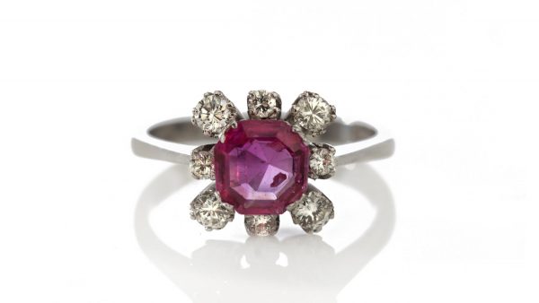 Vintage 1ct Burmese Ruby and Diamond Floral Cluster Ring; set with a natural 1.00 carat octagonal-cut Burmese ruby surrounded by 0.48cts round brilliant-cut diamonds. Circa 1950s-1970s, with Certificate