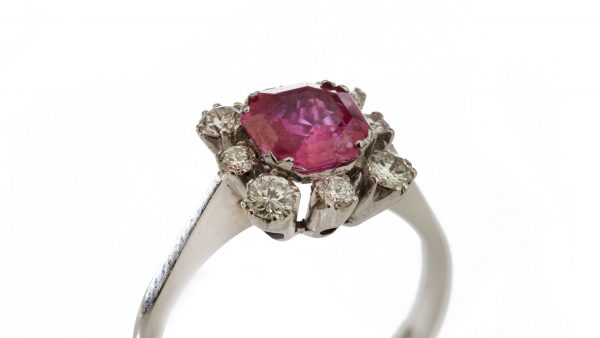 Vintage 1ct Burmese Ruby and Diamond Floral Cluster Ring; set with a natural 1.00 carat octagonal-cut Burmese ruby surrounded by 0.48cts round brilliant-cut diamonds. Circa 1950s-1970s, with Certificate