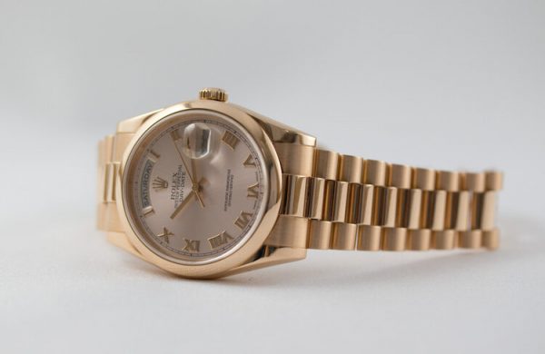 Rolex Day Date 18ct Pink Gold 118205 Automatic Watch, 36mm case with pink dial, on a matching 18ct pink gold Rolex President bracelet, Rolex green protection sticker present on the case back. In mint condition and comes with Rolex box