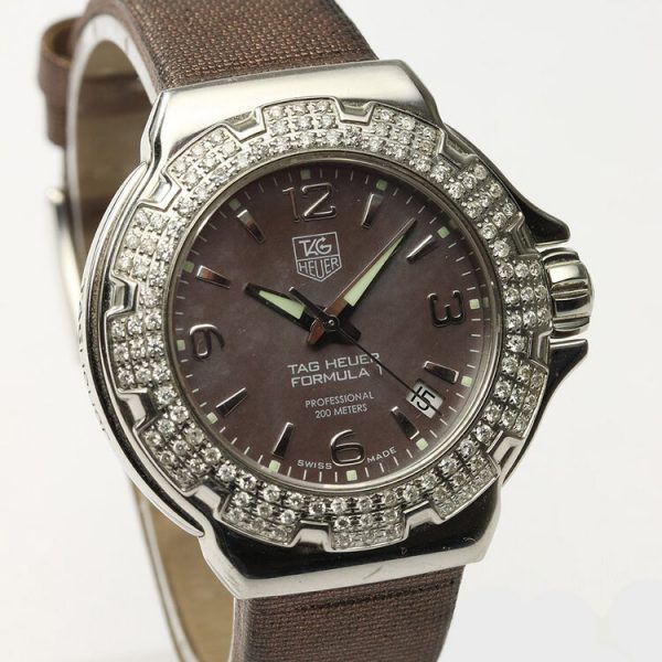 Tag Heuer Formula 1 Ladies Sparkling Diamond Bezel Mother of Pearl Dial Watch; Ref. WAC1217, 36mm stainless steel case with original diamond bezel, brown mother of pearl dial, four Arabic numerals, date indicator, screwdown crown and sapphire crystal, Quartz movement, on a TAG Heuer brown satin/leather strap with Tag Heuer buckle