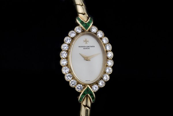 Vintage Vacheron Constantin 18ct Yellow Gold Watch with Diamonds and Emeralds; solid 18ct gold ladies manual wristwatch with diamond bezel accented with emerald set terminals. Made in Switzerland, Circa 1950s
