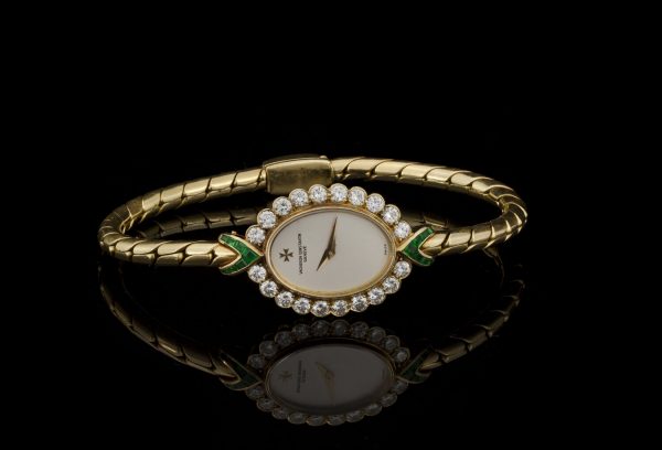 Vintage Vacheron Constantin 18ct Yellow Gold Watch with Diamonds and Emeralds; solid 18ct gold ladies manual wristwatch with diamond bezel accented with emerald set terminals. Made in Switzerland, Circa 1950s