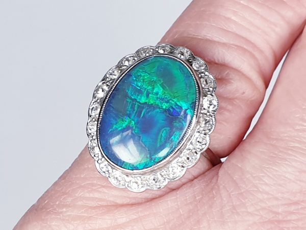 Vintage Cabochon Black Opal and Old Cut Diamond Oval Cluster Dress Ring, 18ct white gold. Circa 1940s
