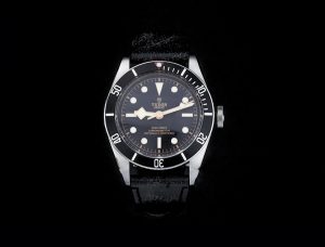 Tudor Heritage Black Bay Automatic Chronometer Watch; 41mm stainless steel case, black dial with luminescent hands and hour markers, unidirectional rotating bezel, and screw-down crown, on black leather strap with deployment buckle, certified, with box and papers