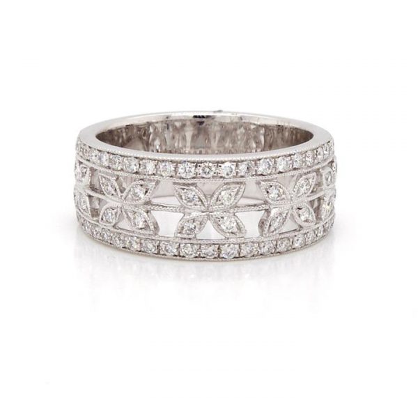 Ornate Diamond Half Eternity Ring; ornate pierced design with fine millegrain setting work, two outer diamond-set bands with central petal-shaped diamond-set kisses, 0.49 carat total, in 18ct white gold