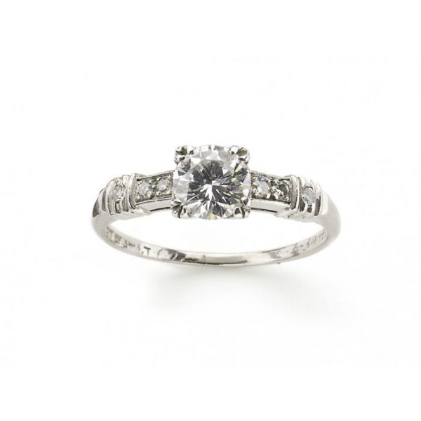 Vintage 0.61ct Diamond Engagement Ring in Platinum; single stone diamond ring featuring a 0.61 carat round brilliant-cut diamond, four claw set, with diamond set shoulders. Circa 1940. Accompanied by a diamond certificate