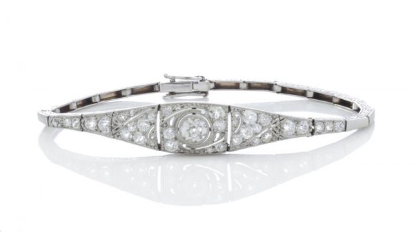 Belle Epoque Diamond and Platinum Bracelet; set with 1.20 carat old-cut diamonds, articulated links with scrolled detail to sides, Circa 1910