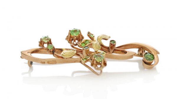 Antique Russian Demantoid Garnet Brooch Pendant in 14ct Rose Gold; featuring a stunning array of rose-cut demantoid garnets arranged in a delicate floral pattern, 19th century, Circa 1890
