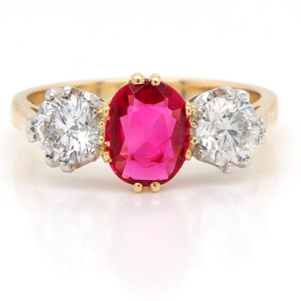 Red Spinel and Diamond Three Stone Ring; featuring a stunning red spinel, flanked either side by a round brilliant cut diamond, in 18ct yellow gold. Diamonds 1.00 carat total, G/H colour, SI clarity