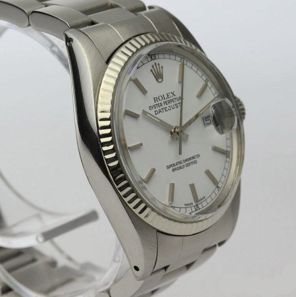 Vintage Rolex Oyster Perpetual Datejust 16014 36mm Stainless Steel Automatic; white dial, baton hour markers, quick-set magnified date, white gold bezel, acrylic crystal and screwdown crown, on a stainless steel Oyster bracelet with fold-over clasp, Circa 1980s