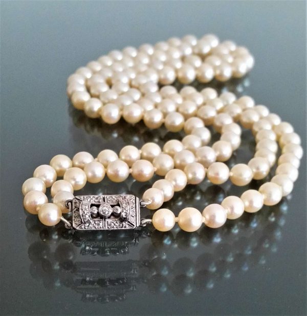 Vintage Akoya Pearl Two Row Necklace with Diamond Clasp; graduated double row of Akoya cultured pearls on a platinum and white gold clasp set with 0.25cts old cut diamonds, Circa 1940s