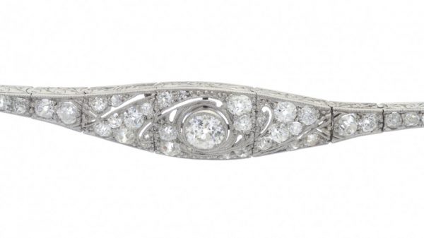 Belle Epoque Diamond and Platinum Bracelet; set with 1.20 carat old-cut diamonds, articulated links with scrolled detail to sides, Circa 1910