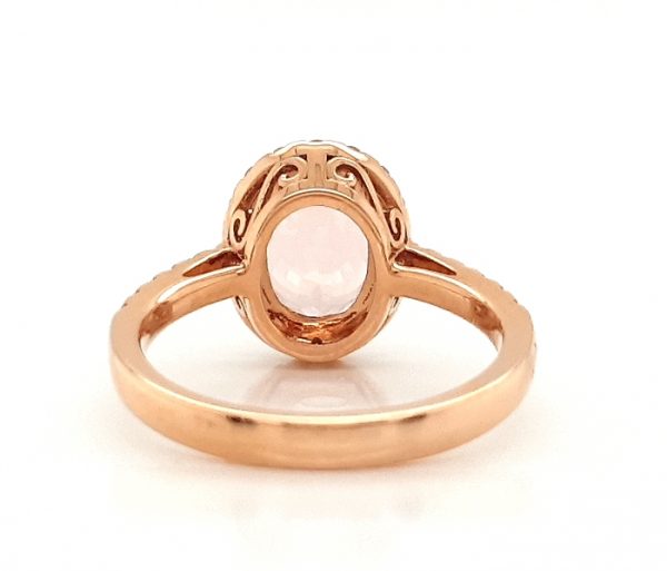 Morganite and Diamond Oval Cluster Ring; oval faceted 2.54 carat morganite with by a diamond halo and diamond set shoulders, in 18ct rose gold