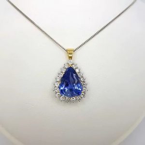 Natural Sapphire and Diamond Pear Cluster Pendant; featuring a 8.58 carat natural pear cut sapphire from Madagascar with 2cts brilliant diamond surround, Certified