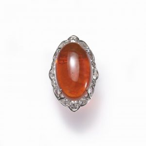 Cabochon Fire Opal and Diamond Cluster Ring in Platinum; central 18.00 carat oval shaped cabochon-cut fire opal, surrounded by 2.40cts brilliant and pear-cut diamonds