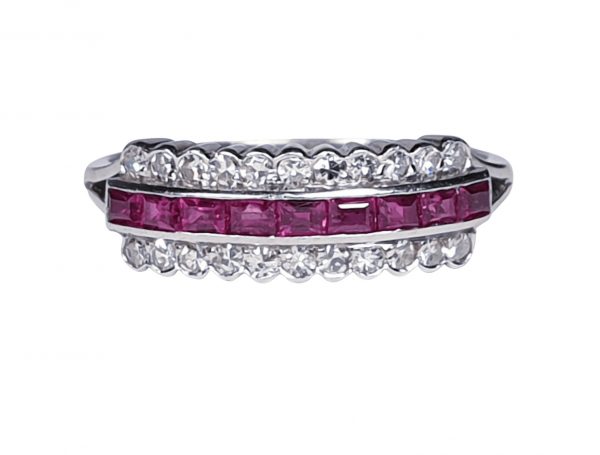 Art Deco Ruby and Diamond Half Hoop Eternity Ring; central band of 0.20cts calibre-cut rubies with a row of brilliant-cut diamonds either side, in rubover settings in platinum. Circa 1920