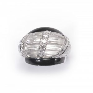 Vintage David Webb Rock Crystal, Diamond and Enamel Bombe Cocktail Ring; the carved raised rock crystal centre containing three columns of round brilliant-cut diamonds, black enamel shoulders, in platinum and 14ct white gold. Stamped "WEBB". Circa 1980