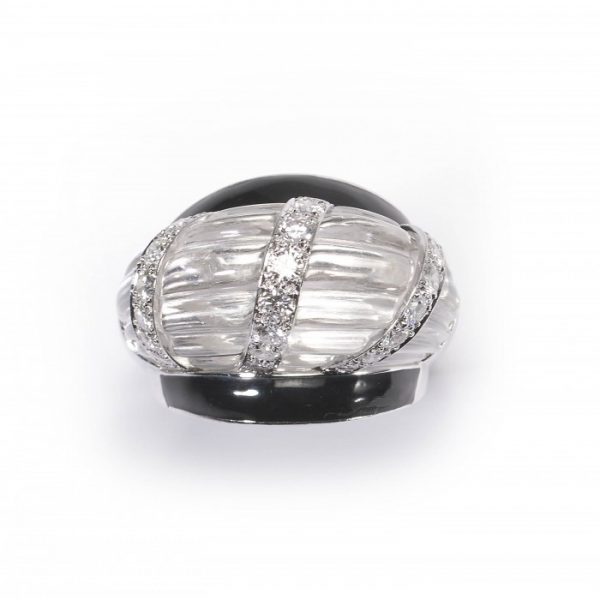 Vintage David Webb Rock Crystal, Diamond and Enamel Bombe Cocktail Ring; the carved raised rock crystal centre containing three columns of round brilliant-cut diamonds, black enamel shoulders, in platinum and 14ct white gold. Stamped "WEBB". Circa 1980