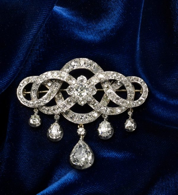 Antique Georgian Pear Drop Old Cut Diamond Brooch, 13.00 carat total, diamond set interwoven scrolls around a cluster centre with five detachable graduating pear-shaped diamond drops, in silver and 18ct gold. Circa 1825-1830